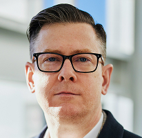 Alexander Hughes, CEO van een crypto trading bedrijf, headshot.